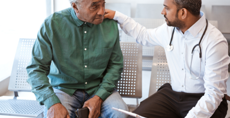 A picture of a doctor and patient talking to eachother.