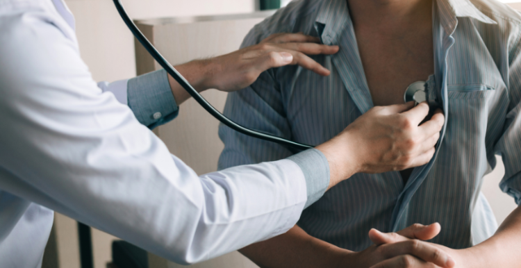 A doctor doing a health check up on a patient using a stethoscope 