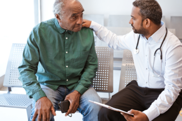 A picture of a doctor and patient talking to eachother.