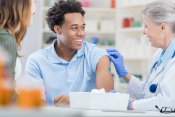 Picture of a doctor administering a vaccine to a patient.