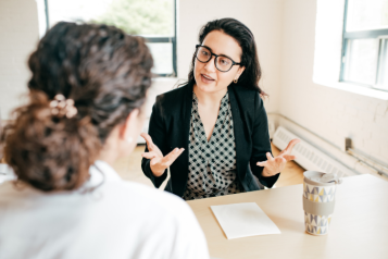 A healthcare professional offering lifestyle advice to a young person.