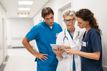 Doctor and Nurse Discussing Patient Case at Hospital